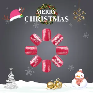 Close-up of red glitter press-on nails featuring white snowflake patterns for Christmas