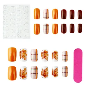 Short square press-on nails set with maple leaf patterns and fall plaid designs