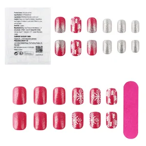 Short square press-on nails with white snowflakes, Christmas trees, and glitter patterns
