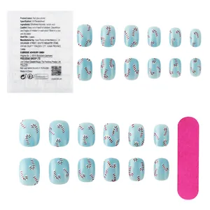 Detail of Christmas press-on nails set with candy cane patterns and pink nail file