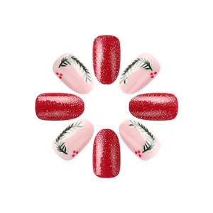 Short round Christmas press-on nails with red glitter and hand-painted pine branch design
