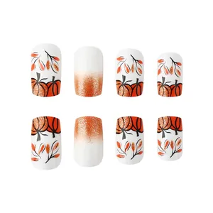 Autumn Halloween press-on nails set featuring orange pumpkins and golden leaf designs