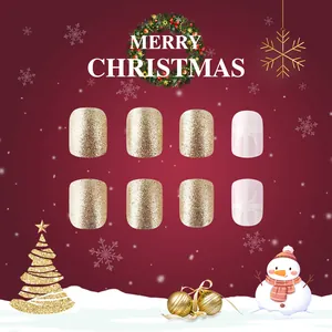 Short glossy Christmas press-on nails with red ribbon, gold glitter, and snowflake art