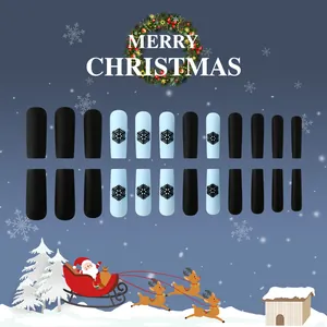 Matte Christmas press-on nails with blue snowflake patterns in a long coffin shape