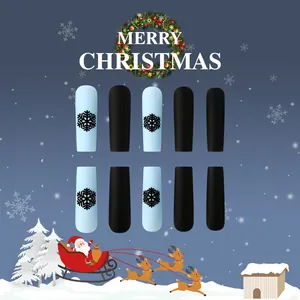 Detail of matte blue and black coffin press-on nails with snowflake Christmas patterns