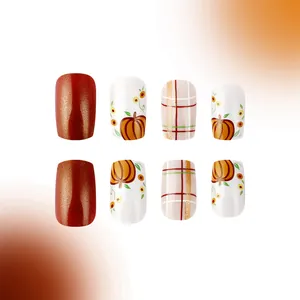 Short square press-on nails with pumpkin patterns and metallic glitter grid for autumn