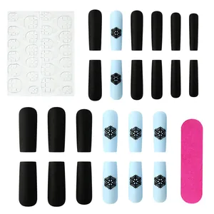 Christmas press-on nails set with matte black and blue snowflake designs and nail tools