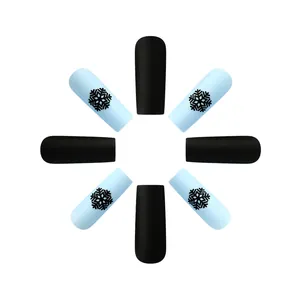 Matte Christmas press-on nails with blue snowflake patterns and black frosted finish