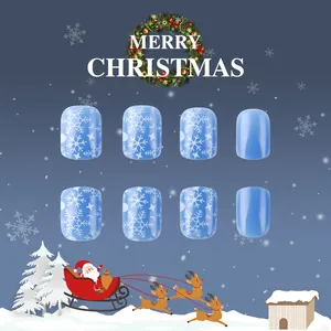 Detail of glossy short square press-on nails with blue snowflake and starry night patterns