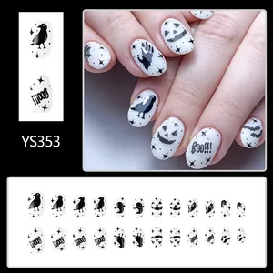 Detail of Halloween press-on nails featuring white and black spider webs and ghosts