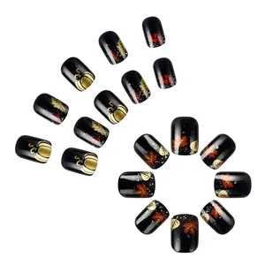 Short square glossy press-on nails featuring autumn maple leaves and golden pumpkin designs