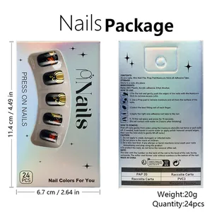 Detail of autumn press-on nails set with gold pumpkins and red maple leaves in packaging