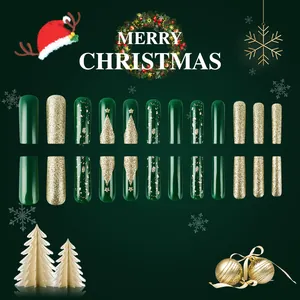 Detailed view of Christmas press-on nails featuring dark green and gold tree patterns