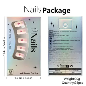 Macro view of pink gradient press-on nails set with red glitter hearts and tools
