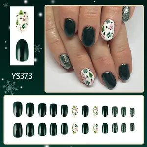Short oval Christmas false nails in green and white with glitter tree patterns