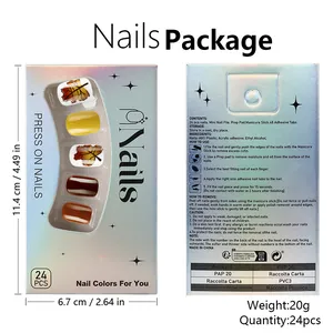 Detail view of maple leaf press-on nails set with tools and shiny holographic packaging
