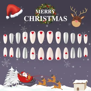 Detailed view of Christmas press-on nails featuring red hearts and silver glitter elk designs