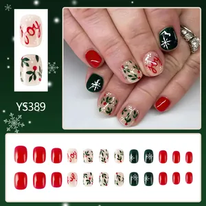 Short square Christmas press-on nails with red snowflakes and Joy lettering design