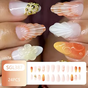 Detail of 24pcs 3D shell flower press-on nails with orange gradient and gold studs