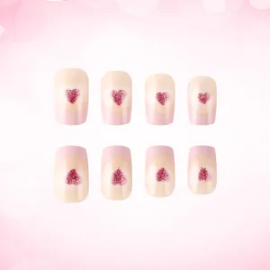 Pink French press-on nails with red glitter heart design in a short square shape