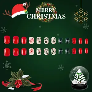 Christmas press-on nails featuring red and green snowflake designs with festive joy lettering