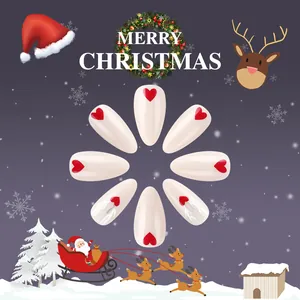 Close-up of Christmas press-on nails with red heart patterns and reindeer antler designs