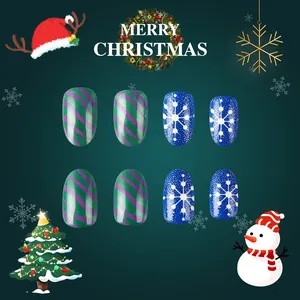 Close-up of Christmas press-on nails with green stripes and snowflake patterns