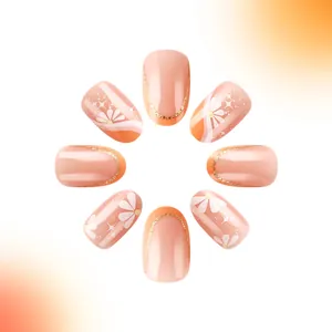 Detail of short French press-on nails featuring daisy patterns and gold glitter accents