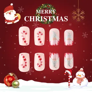 Short square press-on nails with pink base featuring Santa and candy cane glitter art