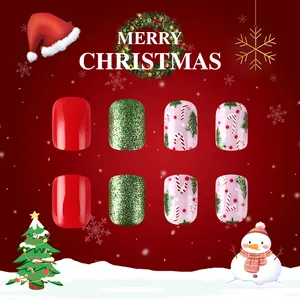 Close-up of Christmas press-on nails featuring glitter, candy cane stripes, and trees