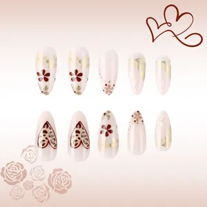Almond leopard heart press-on nails set with pink floral designs and golden glitter finish