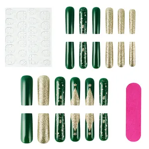 Detailed view of Christmas press-on nails featuring green trees and gold glitter accents
