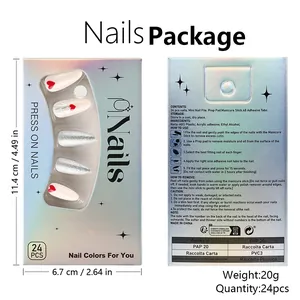 Detailed view of press-on nail kit box with red hearts and silver glitter design
