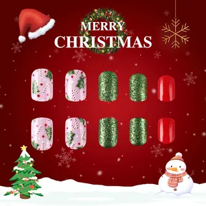 Short glossy Christmas press-on nails featuring tree, candy cane and red polka dot art