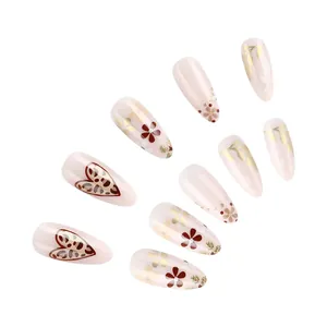 Detail of almond fake nails featuring leopard print hearts and red floral patterns