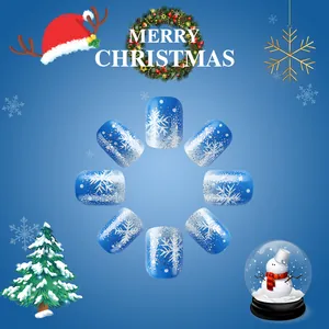 Blue glitter Christmas fake nails with white snowflakes and festive holiday ornaments