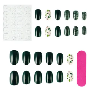 Glossy Christmas press-on nail kit with green glitter, tree designs, and tools
