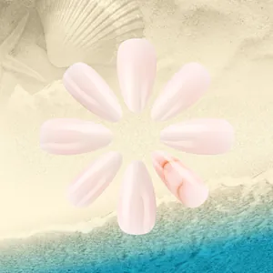 Artistic arrangement of almond press-on nails with marble texture and seashell decor