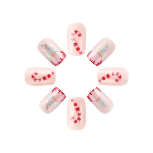 Detail of pink press-on nails featuring Santa gnome and candy cane glitter art