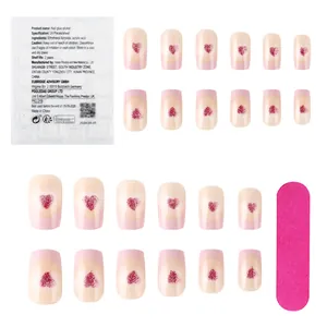 Pink glossy square press-on nails set with red glitter hearts and manicure tools
