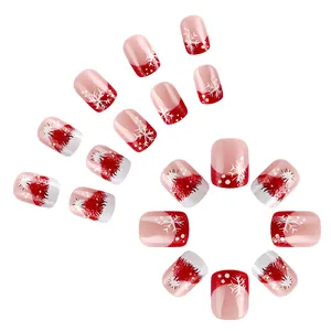 Short square Christmas press-on nails featuring red French tips and white snowflake patterns