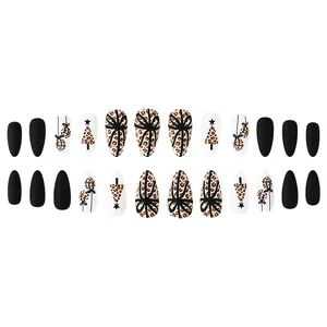 Detailed view of matte black and leopard print press-on nails with Christmas tree art