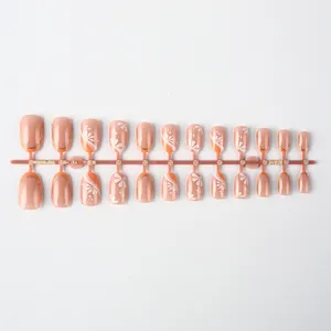 Detail of 24pcs press-on nails set featuring orange-pink petals and daisy floral patterns