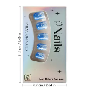 Close-up of blue gradient press-on nails with white snowflakes and glitter details