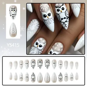 Detailed views of almond Christmas fake nails with cute owl and white snowflake patterns