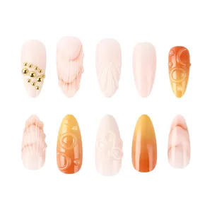 3D floral embossed press-on nails in pink and amber marble with gold bead accents