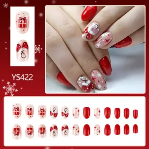 Detail of Christmas press-on nails set featuring red glove and gift box patterns