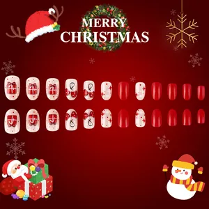 Christmas press-on nails with red gift boxes and white star patterns on a festive backdrop