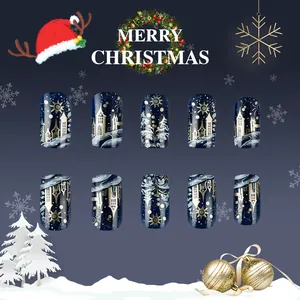 Detail view of blue Christmas press-on nails with gold castle and snowflake patterns