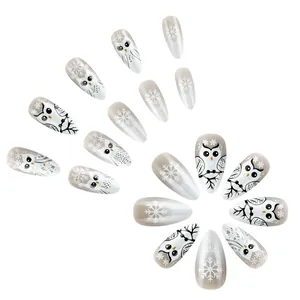 Short almond Christmas fake nail set with owl and snowflake patterns on white background